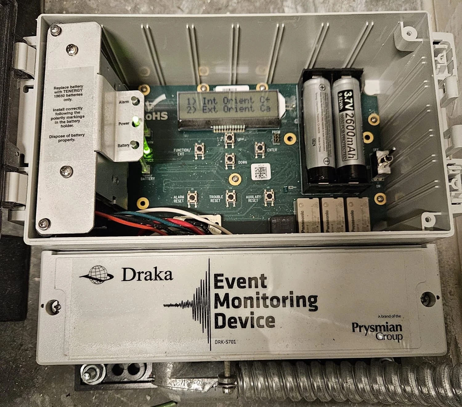 Elevator mechanic repairing control cabinet panel
